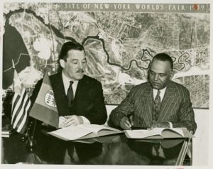 Grover Whalen signing a fair contract with a Liberian delegate circa 1938