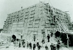 Men at the base of the unfinished pedestal C. 1884.