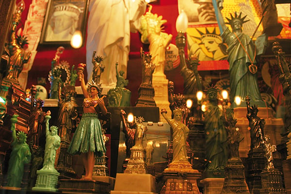 Many models of the Statue of Liberty in different sizes and materials on display at the City Reliquary