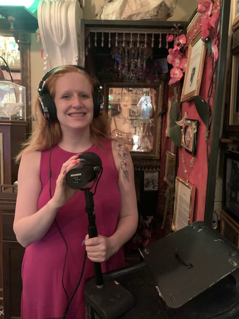 Maggie McMuffin holding a micrphone