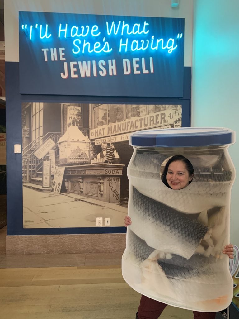 Tania Mohammad wearing a herring jar costume, at the I'll Have What She's Having: The Jewish Deli museum exhibition