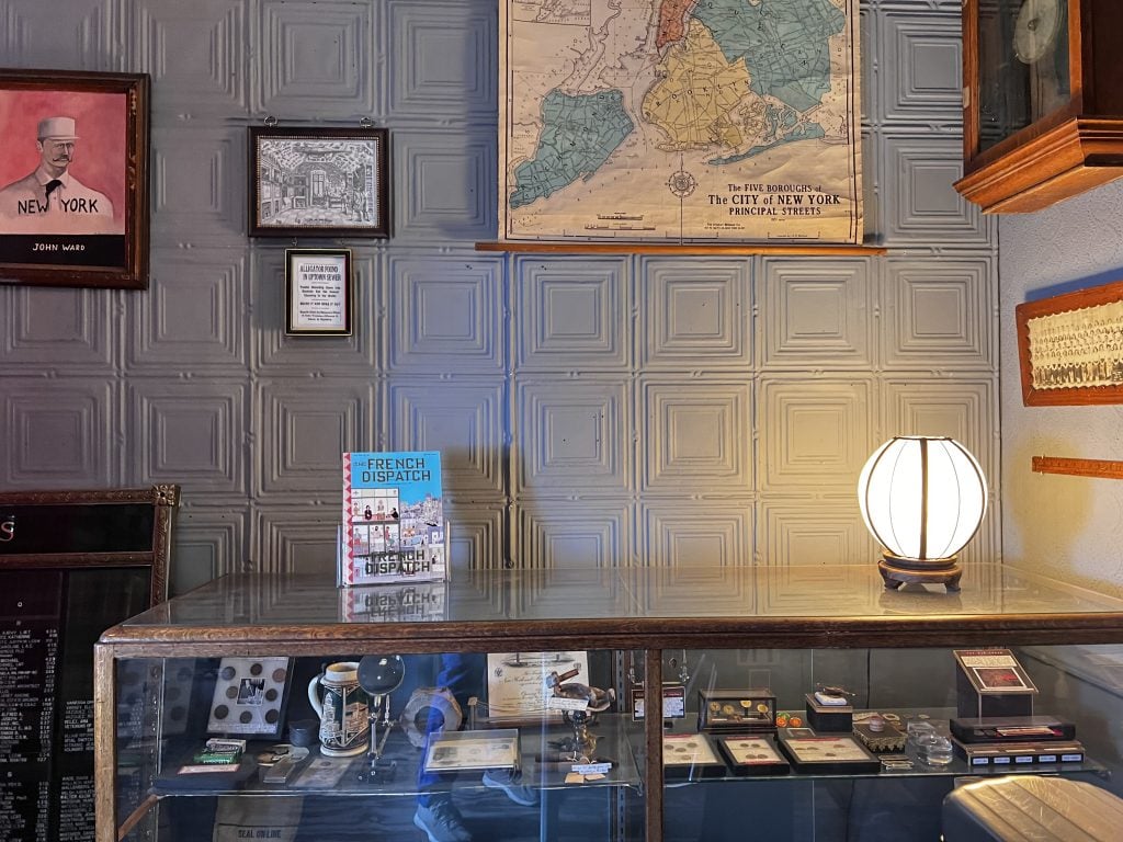 Wall of the Reliquary front room, featuring old NYT headline ALLIGATOR FOUND IN UPTOWN SEWER below Ferrante Imperato's Dell’historia Naturale print