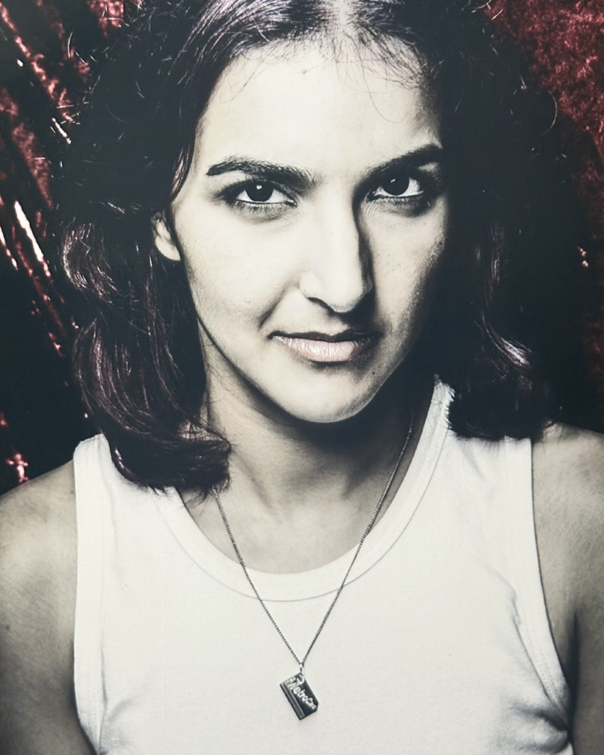Alicia Kalsi in a white tank top