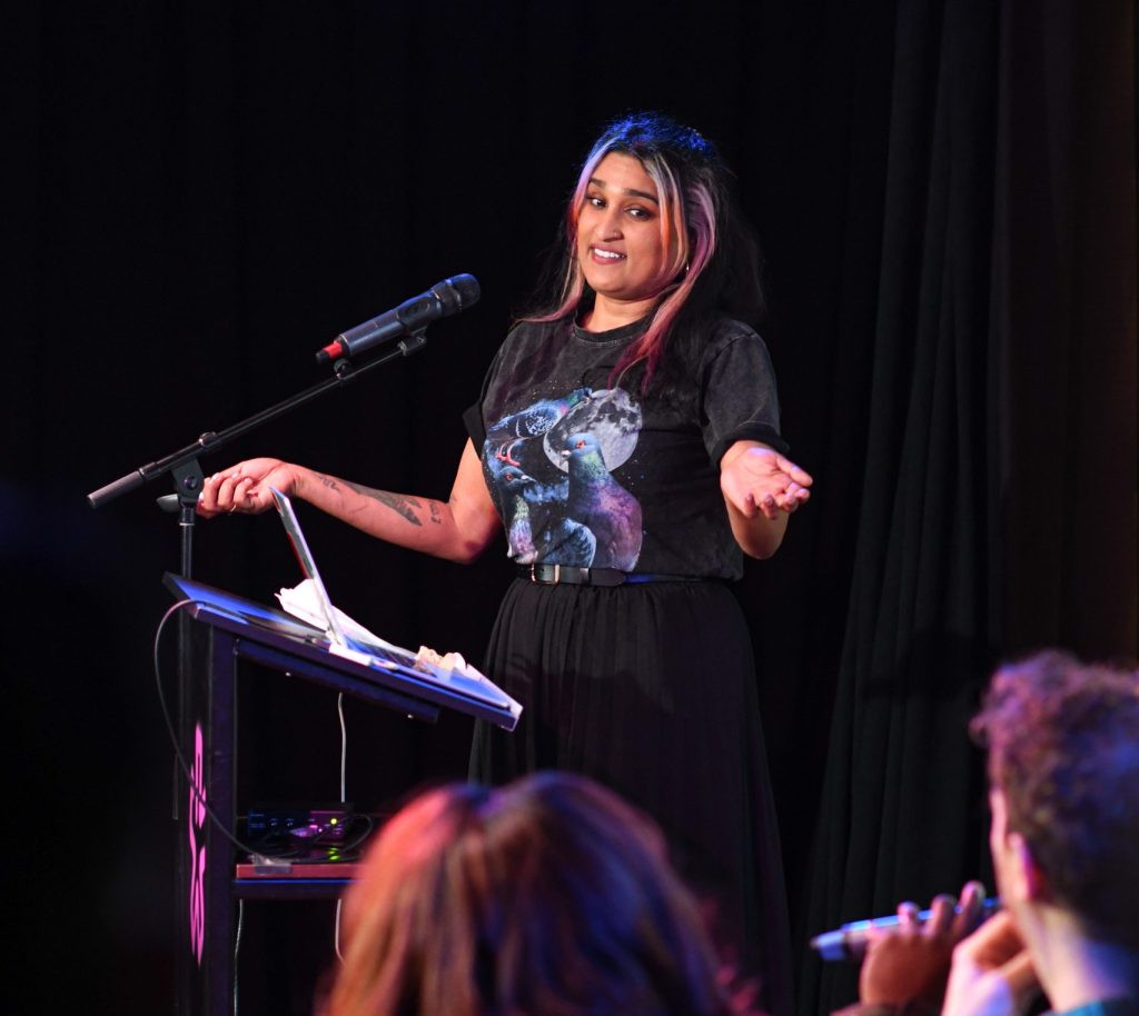 Jess Joseph in a black outfit making a speech