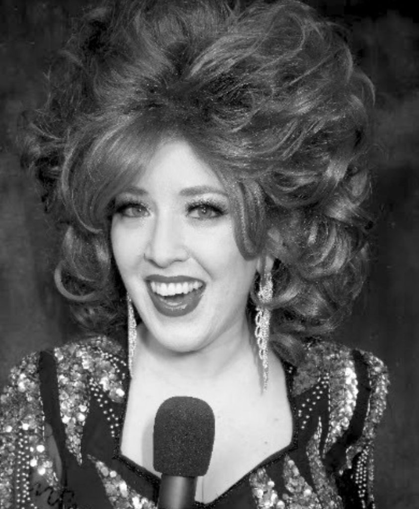 Black and white photo of Trudy Carmichael with large bouffant hair and a fancy dress